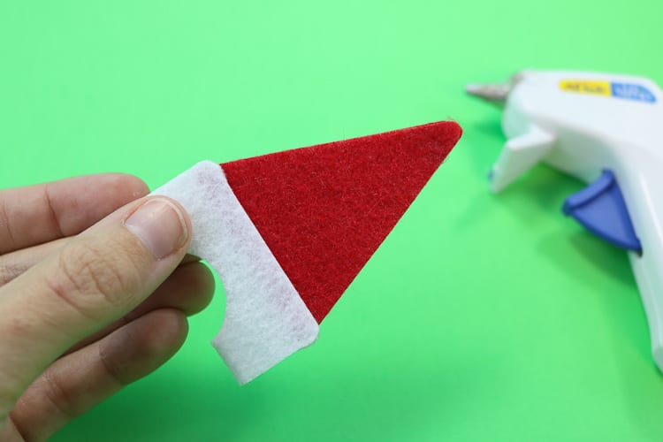 Second Santa Hat Assembly Step is to glue the red triangle tips together