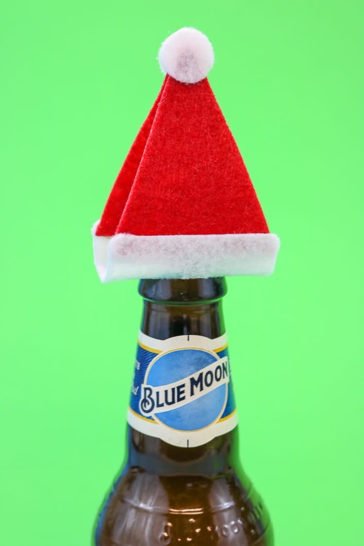 Add the Santa Hats to Tops of Bottles to create a fun "gift wrap" idea for a 6 pack