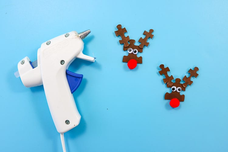 Add red pom pom to puzzle piece as nose of reindeer