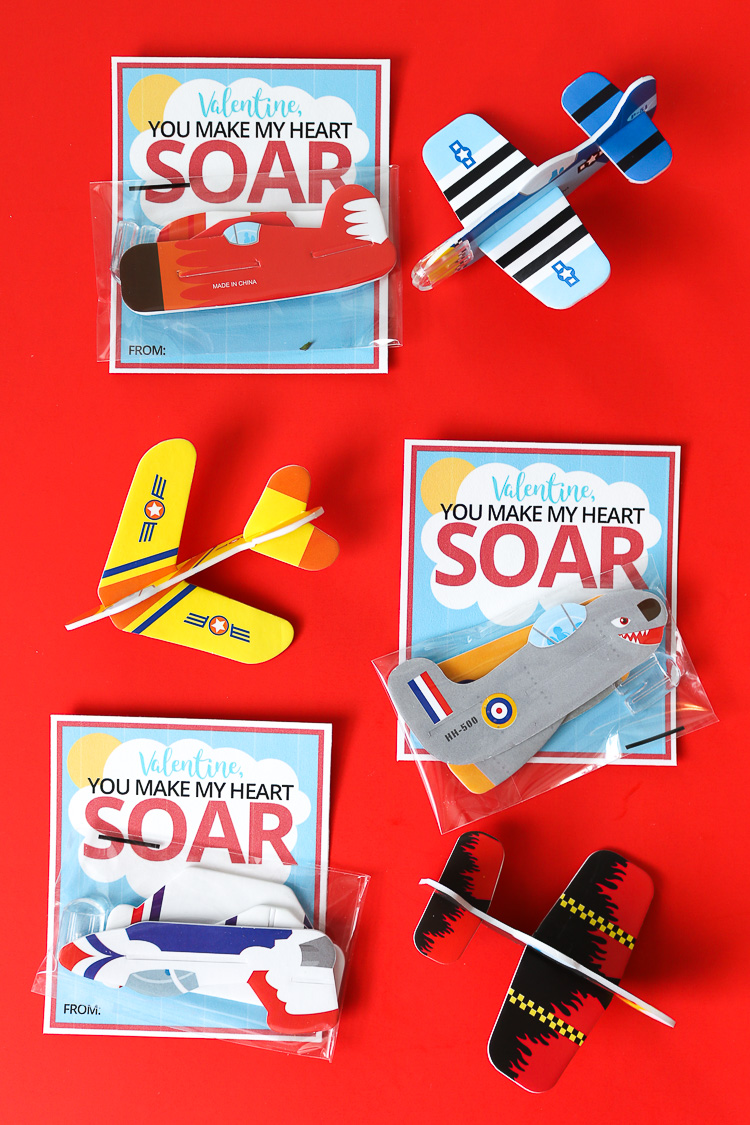 Red background with Airplane Valentine printables with small foam airplanes