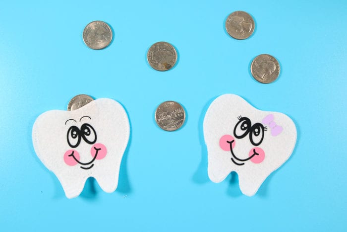 Two Tooth Pouches with Quarters in them 