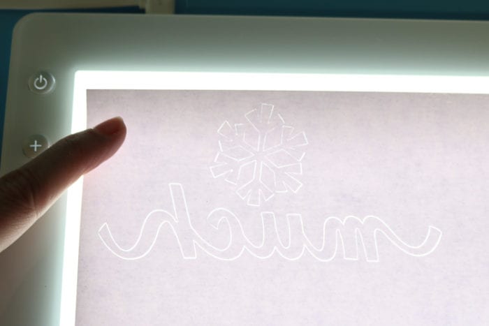 BrightPad Illuminated with White Glitter Vinyl on top to see the cut pattern more easily