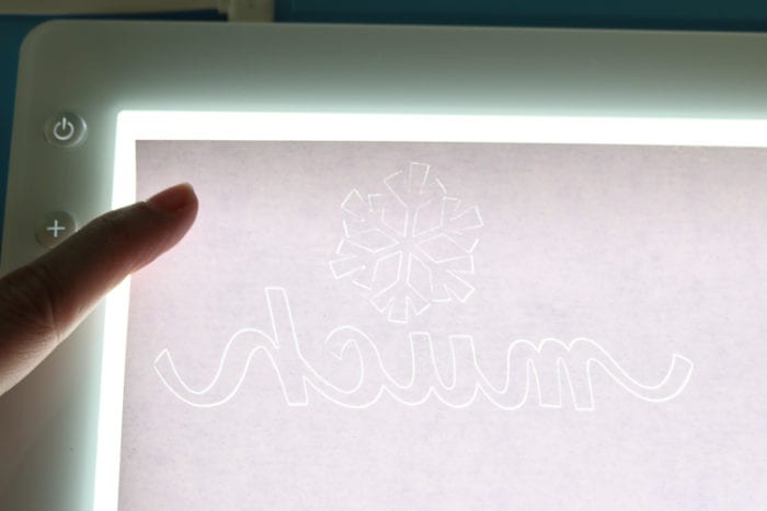Use the Cricut BrightPad to weed glitter vinyl easily BrightPad Illuminated with White Glitter Vinyl on top to see the cut pattern more easily