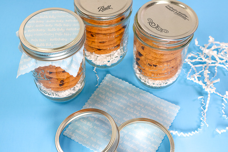 Mason Jars filled with cookies ready to have fabric lids on them