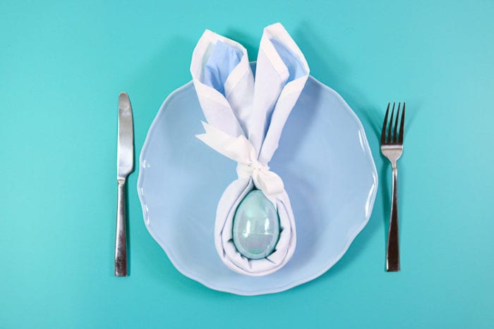 blue plate with blue folded bunny napkin