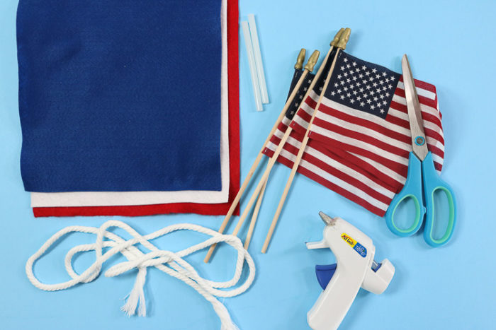 4th of July Banner Supplies: Felt, Small Flags, Rope, Scissors and A hot glue gun with glue sticks