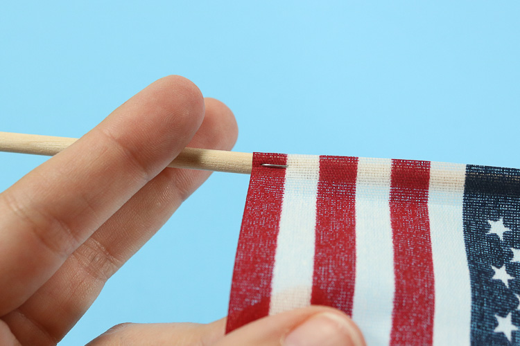 Close up of small staples that hold the flag onto the stick