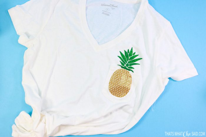 White women's v-neck t-shirt with Pineapple base on pocket and stem on shirt
