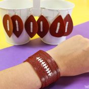 Earrings and bracelet cut from faux football leather