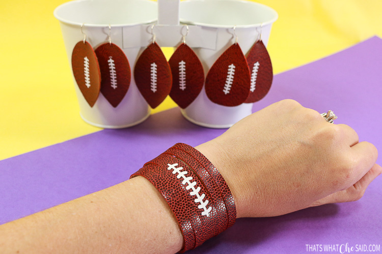 Earrings and bracelet cut from faux football leather