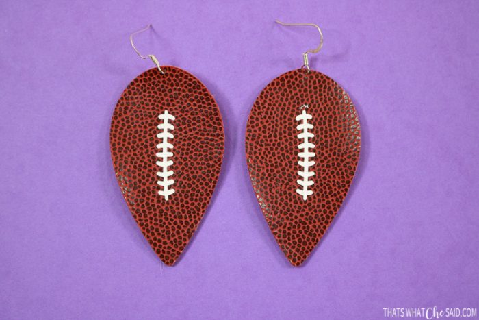 Reverse teardrop earrings cut in faux football leather