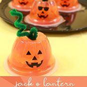 Orange fruit cups with vinyl jackolantern faces to make Halloween snacks