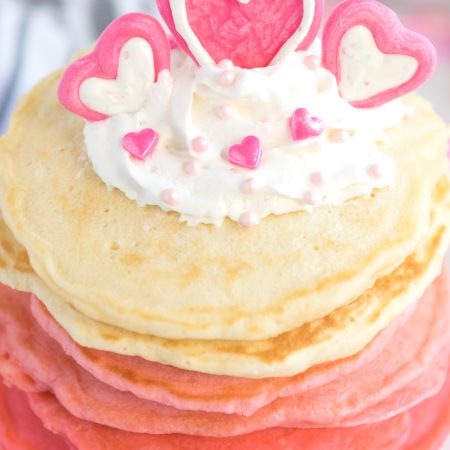 Pancakes stacked from red, dark pink,pink and white