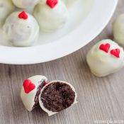 Close up of finished Oreo Truffles and one broken in half to see the chocolaty insides!