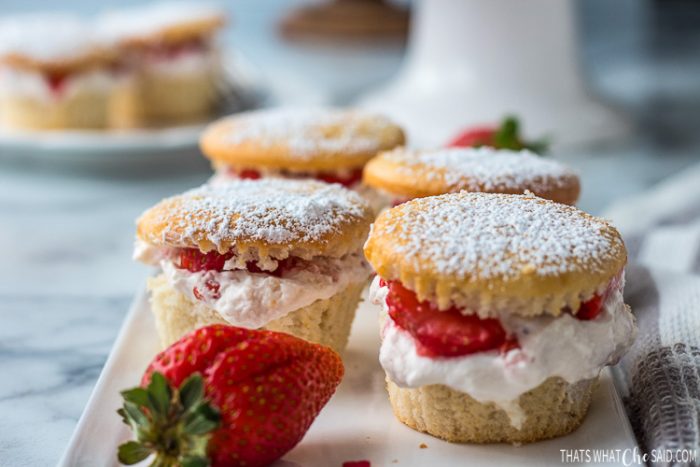 Strawberry Cupcakes on a plate staged and garnished with a strawberry