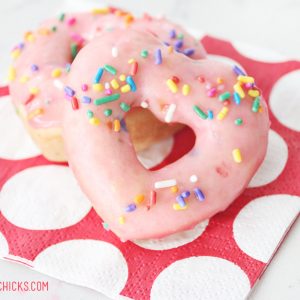 heart shaped donuts with pink frosting and sprinkles