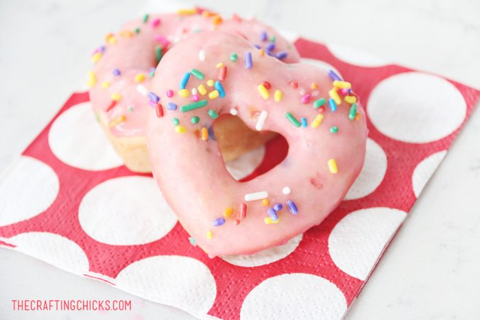 heart shaped donuts with pink frosting and sprinkles