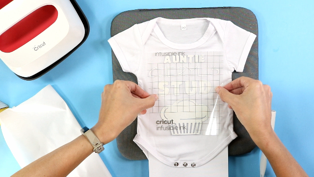placing the design on the baby bodysuit