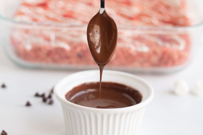 Drizzling on the Chocolate topping with a spoon