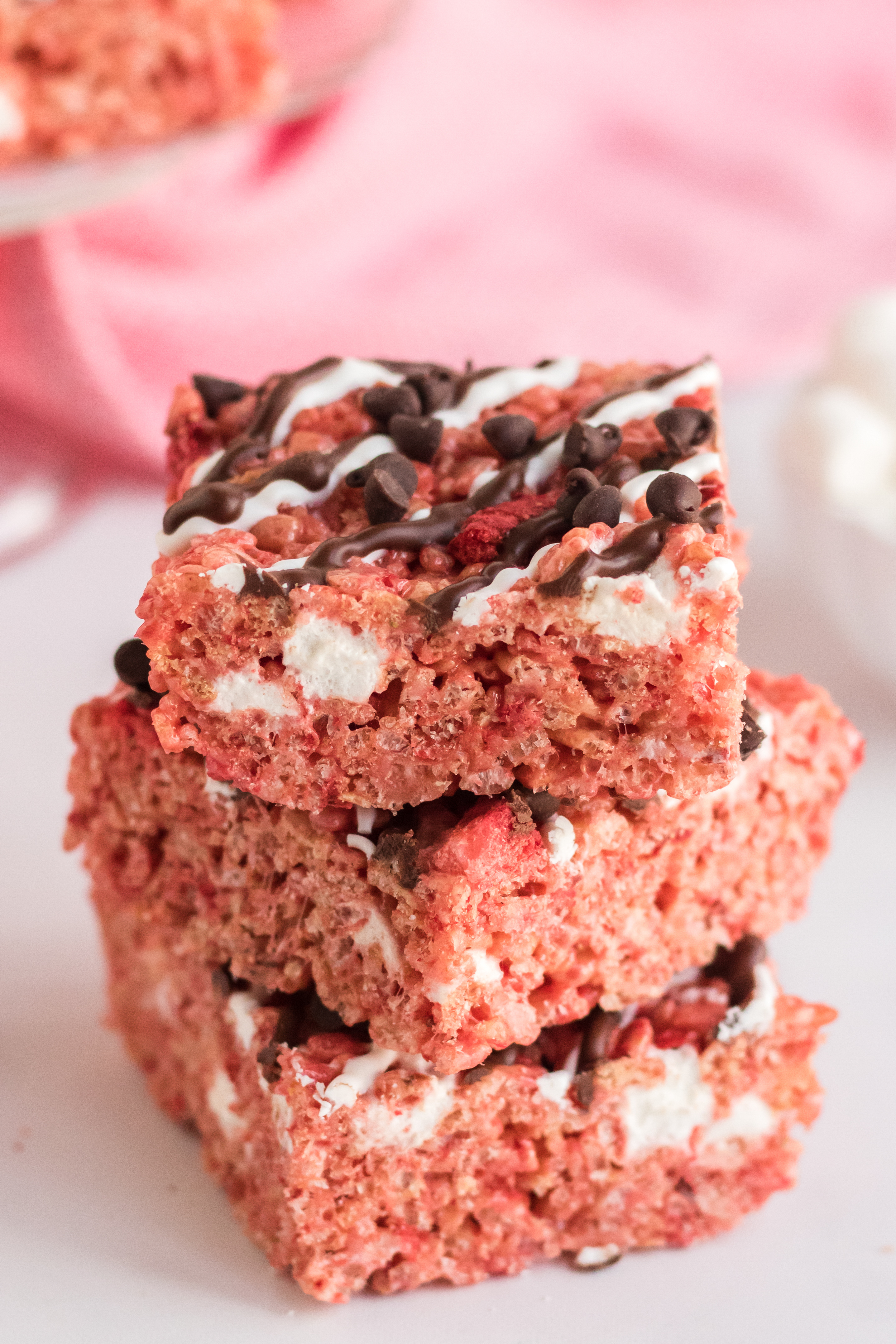 close up of Chocolate Covered Strawberry Rice Krispie Treats stacked three tall