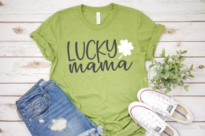 Light Green shirt with jean shorts and white canvas tennis shoes with "Lucky Mama" on the shirt in Iron on