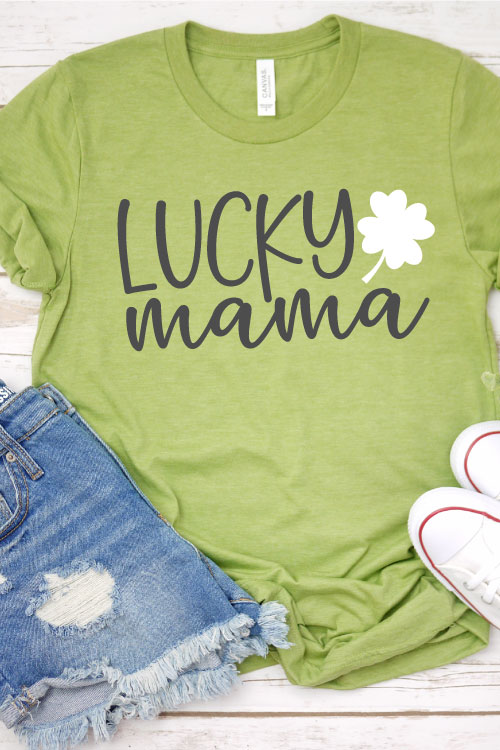 Green shirt with jean shorts and chuck taylors the shirt ha "Lucky Mama SVG design with 4 leaf clover"