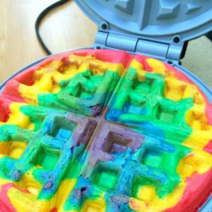 Waffle Iron with Waffle in rainbow colors.