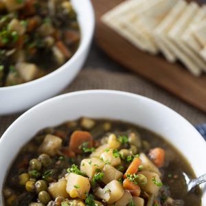 Vegetable Soup in a bowl with saltines in background