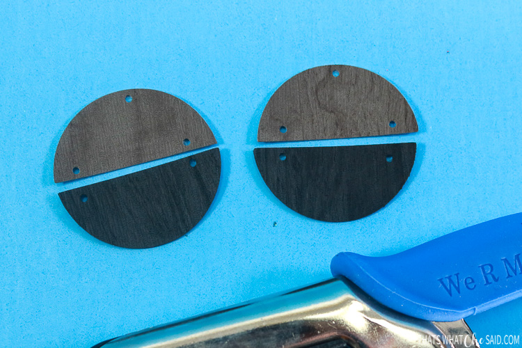 Close up of faux leather earrings with holes punched for jump rings and earring hooks