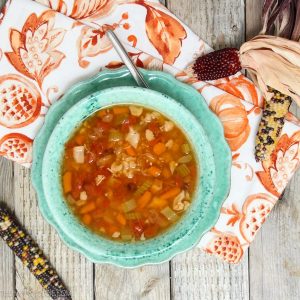 Chicken & Vegetable Bean Soup in aqua bowl on aqua plate with a napkin