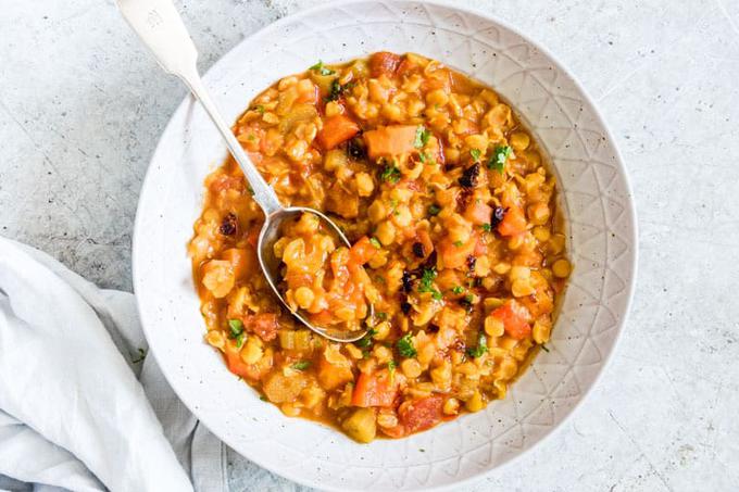 Moroccan Split Pea Soup in white bowl with spoon and white cloth napkin