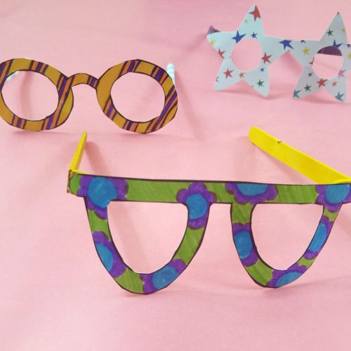 Fake glasses made from colored paper and popsicle sticks or straws.