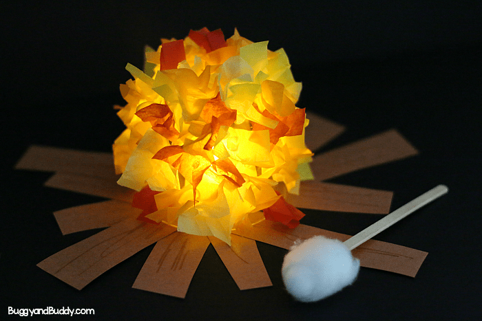 Cute campfire craft made from tissue paper and a jar with a roasting marshmallow made from s popsicle stick and cotton ball.