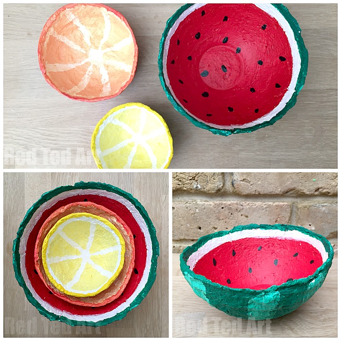 Paper mache bowls that's are painted as cut up summery fruits.