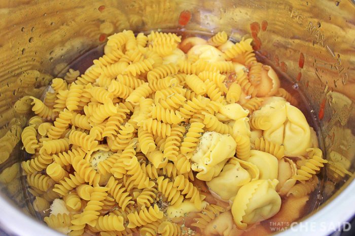 Chicken Parm ingredients in Instant Pot inner pan ready to be cooked