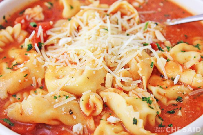 Close up of Chicken Parm Soup with shredded parmesan cheese topping