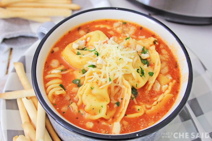 Instant Pot Chicken Parm soup in bowl with crunchy breadsticks