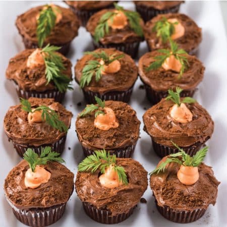 white plate full of carrot patch cupcakes