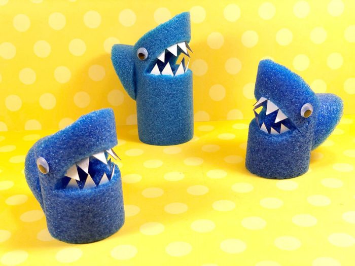 Pool noodles made into sharks with paper teeth and googely eyes.