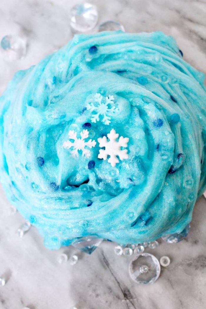 Blue sparkly slime with snowflake charms and blue sequins.