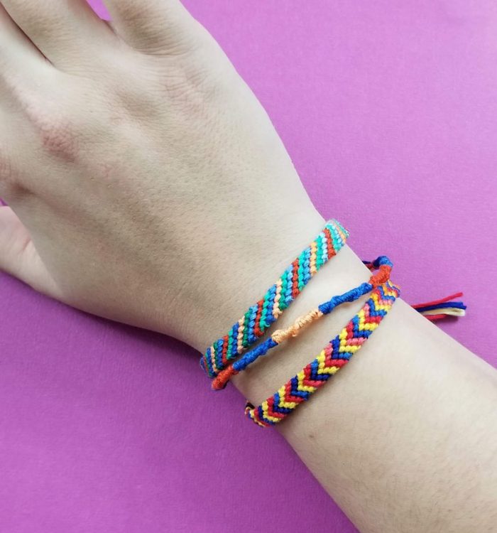 Three different friendship bracelets on a wrist.