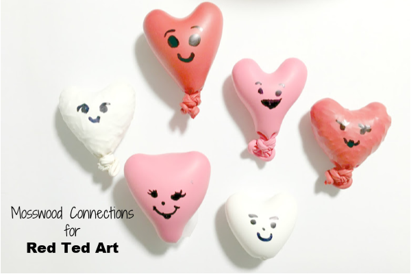 Filled heart balloons with faces for fidgets.