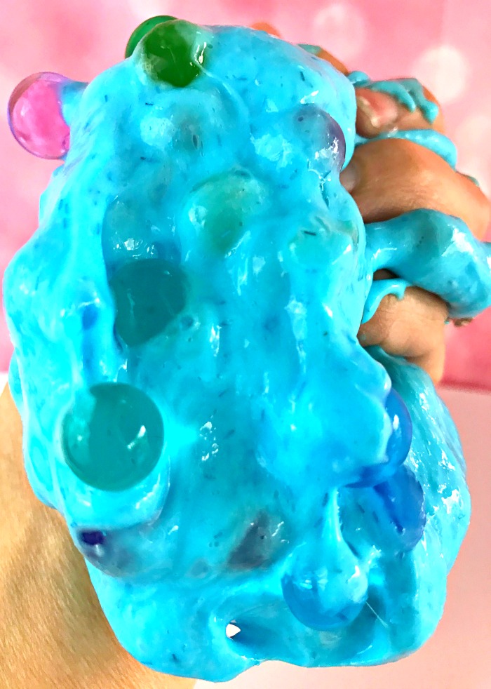Blue sparkly slime filled with orbeez.