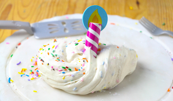 Edible birthday cake flavored white slime with sprinkles.