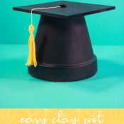Pin. Vertical of finished clay pot grad cap with words at the bottom