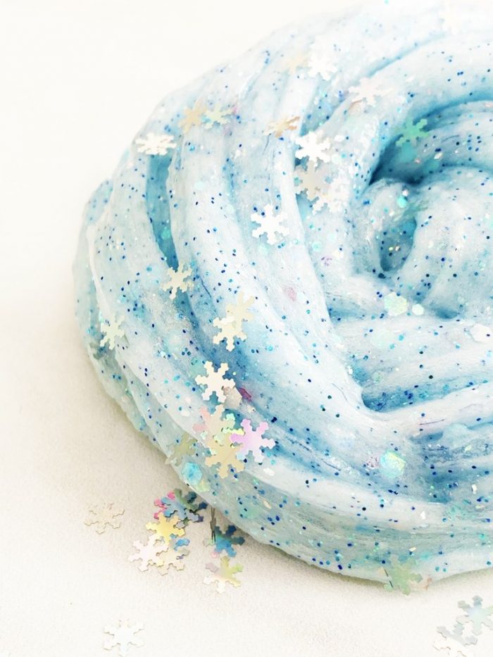 White and blue glitter slime with snowflakes themed off the movie Frozen