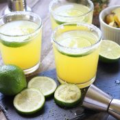 Three Pineapple Margaritas with sliced limes and fresh cut pineapple - Square Format