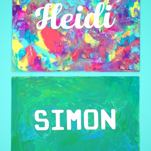 Canvas with blocked out name and paint all around it (silhouette painting)