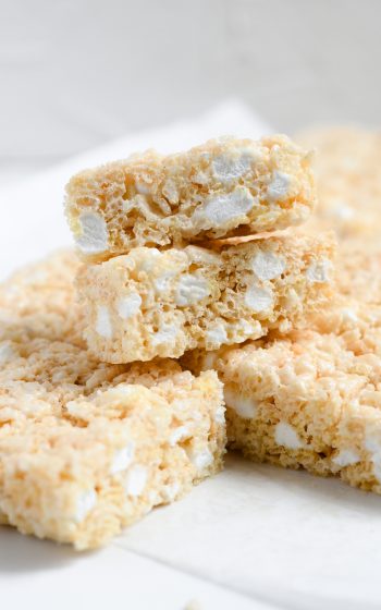 Close up of cut rice krispie treats stacked on a plate