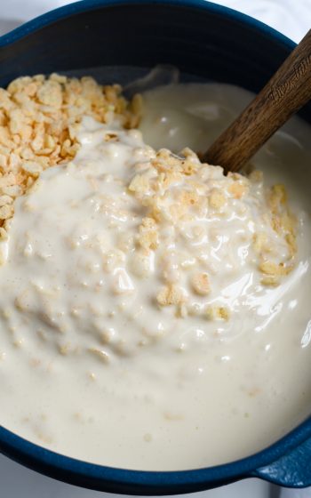 Adding melted butter and marshmallow to Krispies in bowl